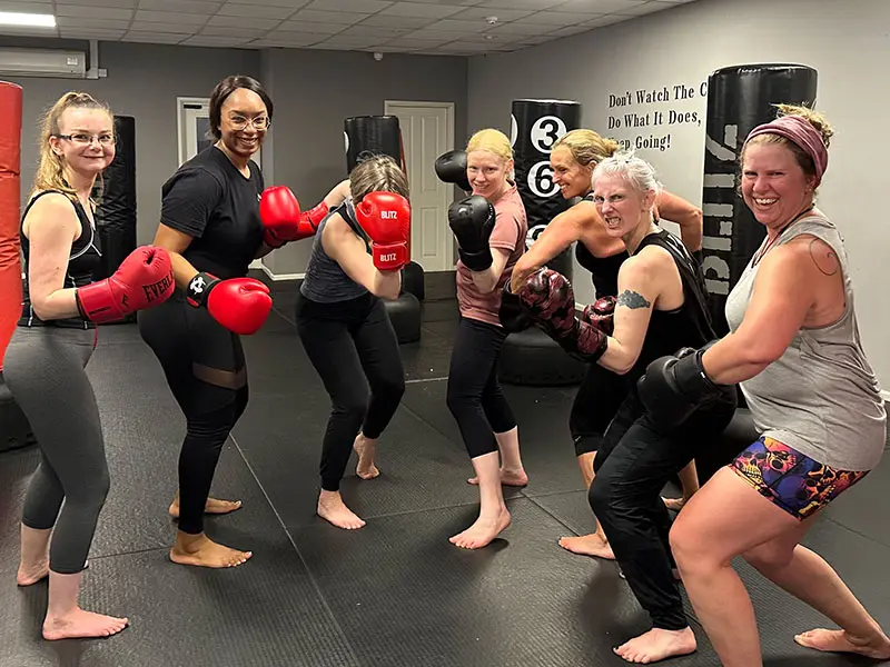 Women geared up and preparing for adult kickboxing