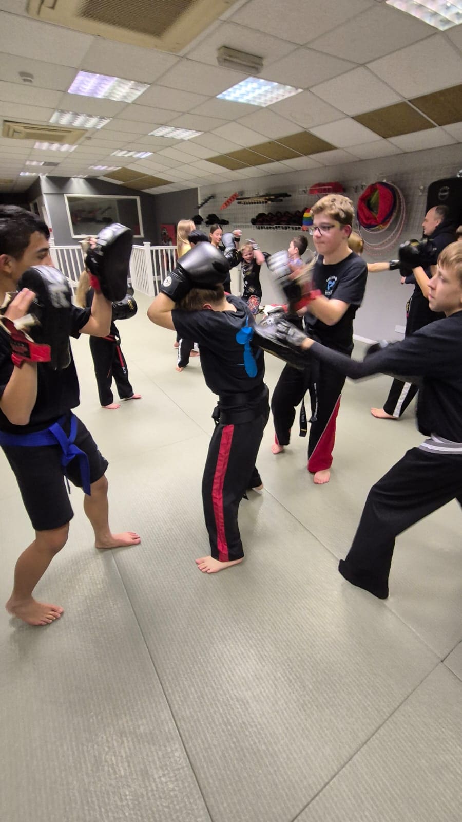 Martial arts teaches kids self-defence and self-control through body language, helping build confidence and improve eye contact across various age groups.