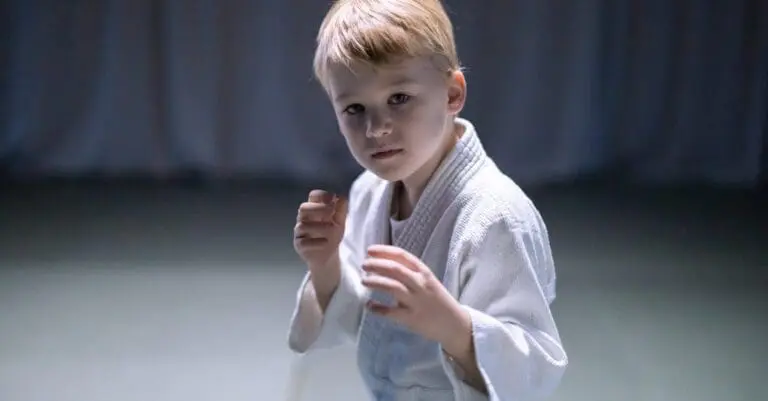 Young student holding a ready stance during practice while developing coordination through kids karate benefits