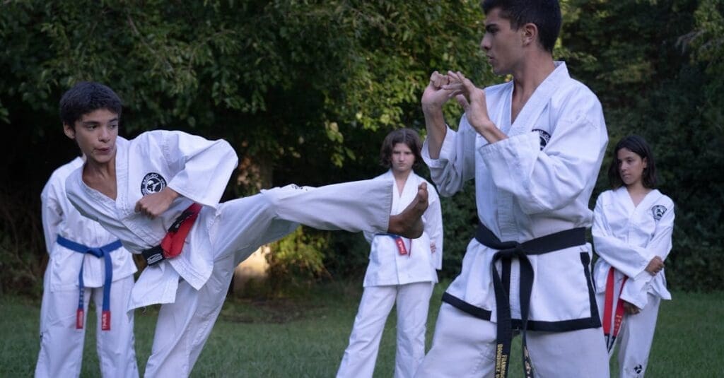 A young practitioner executing a powerful side kick during an outdoor session for a Teen Taekwondo Training Guide.