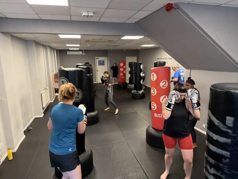Fitness kickboxing class in Cheltenham - women training with pads and gloves